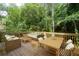 Spacious back deck featuring comfortable seating and a dining area with wooded views at 1096 Polo Club Nw Dr, Marietta, GA 30064
