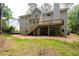 View of the home's backyard featuring a deck with stairs and freshly mulched ground at 1096 Polo Club Nw Dr, Marietta, GA 30064