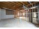 This unfinished basement features concrete flooring, exposed framing and ductwork, and natural light at 1096 Polo Club Nw Dr, Marietta, GA 30064
