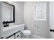 Stylish half bathroom featuring a modern vanity and a decorative stained glass window at 1096 Polo Club Nw Dr, Marietta, GA 30064