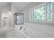 Relaxing bathroom featuring a soaking tub, separate shower, and unique window design, perfect for unwinding after a long day at 1096 Polo Club Nw Dr, Marietta, GA 30064
