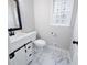 Charming half bathroom featuring modern vanity and elegant stained glass window at 1096 Polo Club Nw Dr, Marietta, GA 30064