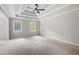 Spacious bedroom featuring a tray ceiling with fan and two windows offering ample natural light at 1096 Polo Club Nw Dr, Marietta, GA 30064