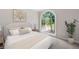 Cozy bedroom with large arched window, neutral decor, and a comfortable bed, creating a relaxing atmosphere at 1096 Polo Club Nw Dr, Marietta, GA 30064