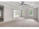 View of a bedroom featuring a tray ceiling with fan and an arched doorway that adds architectural interest at 1096 Polo Club Nw Dr, Marietta, GA 30064