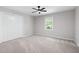 This spacious bedroom features neutral carpet, a ceiling fan, a window, and a closet at 1096 Polo Club Nw Dr, Marietta, GA 30064