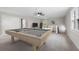 This carpeted bonus room has a pool table, sitting area, and a large window at 1096 Polo Club Nw Dr, Marietta, GA 30064