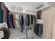Organized walk-in closet with ample hanging space, shelving, and a suitcase, providing efficient storage solutions at 1096 Polo Club Nw Dr, Marietta, GA 30064