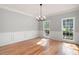 Dining room features hardwood floors, wainscoting, and large windows for ample natural light at 1096 Polo Club Nw Dr, Marietta, GA 30064
