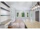 Bright dining area with large windows, hardwood floors, and built-in shelving and granite-topped cabinets at 1096 Polo Club Nw Dr, Marietta, GA 30064