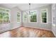Bright dining room with hardwood floors, wainscotting, large windows, and access to outdoor deck at 1096 Polo Club Nw Dr, Marietta, GA 30064