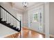Bright foyer with hardwood floors, staircase, and decorative glass accents on the front door at 1096 Polo Club Nw Dr, Marietta, GA 30064