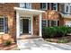 Inviting front door with white columns, decorative windows, and lush landscaping at 1096 Polo Club Nw Dr, Marietta, GA 30064