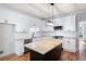 Well-equipped kitchen showcases white cabinets, granite countertops, stainless appliances, and a center island at 1096 Polo Club Nw Dr, Marietta, GA 30064