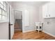This laundry room features wood floors, a wash basin, and stairs to the upper level at 1096 Polo Club Nw Dr, Marietta, GA 30064