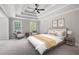 Serene main bedroom with tray ceiling, natural light, neutral color palette and carpet flooring at 1096 Polo Club Nw Dr, Marietta, GA 30064