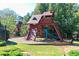 Wooden playground with swings, a slide, and climbing wall offers fun outdoor activities for  at 1096 Polo Club Nw Dr, Marietta, GA 30064