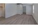 Bedroom featuring gray vinyl plank flooring, white wainscoting, and a view to the rest of the house at 12208 Buchanan Hwy, Temple, GA 30179