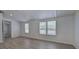 Bedroom featuring gray vinyl plank flooring, white wainscoting, and two windows at 12208 Buchanan Hwy, Temple, GA 30179