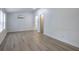 Bedroom featuring gray vinyl plank flooring, white wainscoting, and an ensuite bathroom at 12208 Buchanan Hwy, Temple, GA 30179