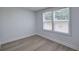 White bedroom featuring neutral paint, wood-look flooring, and natural light at 12208 Buchanan Hwy, Temple, GA 30179
