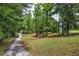 Long gravel driveway leading up to the home and wooded surroundings at 12208 Buchanan Hwy, Temple, GA 30179