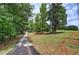 Long, private driveway leading to a home amidst a lush, wooded landscape at 12208 Buchanan Hwy, Temple, GA 30179