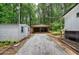 Home exterior featuring gravel driveway and two car open garage at 12208 Buchanan Hwy, Temple, GA 30179