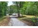 Exterior of home with a large yard, outbuilding, and parking space at 12208 Buchanan Hwy, Temple, GA 30179