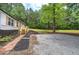 Home exterior with a new deck, gravel parking and mulch bed at 12208 Buchanan Hwy, Temple, GA 30179