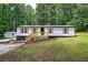 Inviting single-story home featuring wood accents and a well-maintained lawn at 12208 Buchanan Hwy, Temple, GA 30179