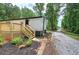 Charming home featuring a newly constructed wood deck, landscaped yard, and a gravel driveway at 12208 Buchanan Hwy, Temple, GA 30179