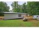 Exterior view of home features lush backyard and wood deck at 12208 Buchanan Hwy, Temple, GA 30179