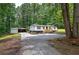 View of exterior of the home with an outbuilding and ample parking at 12208 Buchanan Hwy, Temple, GA 30179