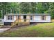 Well-kept single-story home with a cozy porch and manicured landscaping at 12208 Buchanan Hwy, Temple, GA 30179