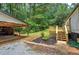 Home exterior featuring two car open garage and new wooden deck at 12208 Buchanan Hwy, Temple, GA 30179