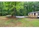 Home exterior with well-kept lawn, mature trees and new front deck at 12208 Buchanan Hwy, Temple, GA 30179