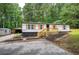 Charming single-story home with a welcoming porch and lush green surroundings at 12208 Buchanan Hwy, Temple, GA 30179