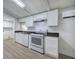 Bright kitchen featuring white cabinets, stone countertops, and stainless steel appliances at 12208 Buchanan Hwy, Temple, GA 30179