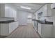 Modern kitchen with stainless steel appliances, white cabinets, and stylish gray countertops at 12208 Buchanan Hwy, Temple, GA 30179