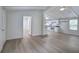 Open-concept living room features modern floors seamlessly flowing into the kitchen at 12208 Buchanan Hwy, Temple, GA 30179