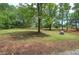 The spacious property features mature trees and a natural rock feature at 12208 Buchanan Hwy, Temple, GA 30179