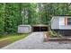 Driveway shot showing an outbuilding and parking area beside home at 12208 Buchanan Hwy, Temple, GA 30179