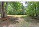 A beautiful, partially wooded yard offers privacy and potential for outdoor enjoyment at 12208 Buchanan Hwy, Temple, GA 30179
