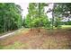 View of the yard and wooded property with a gravel drive leading to a home at 12208 Buchanan Hwy, Temple, GA 30179