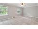 Spacious bedroom with plush carpeting, large windows, and ceiling fan for added comfort at 1731 Twin Brooks Se Dr, Marietta, GA 30067