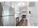 Well-lit kitchen with stainless steel appliances, granite countertops and white cabinets at 1731 Twin Brooks Se Dr, Marietta, GA 30067