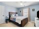 Comfortable bedroom featuring a ceiling fan, window with curtains, and a wood-frame bed at 3519 Wellsley Dr, Powder Springs, GA 30127
