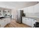 Charming kitchen features stainless steel appliances, ample cabinet space and hardwood floors at 3519 Wellsley Dr, Powder Springs, GA 30127