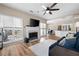 Bright living room features a fireplace, ceiling fan, and hardwood floors, with view to outdoor patio at 3519 Wellsley Dr, Powder Springs, GA 30127